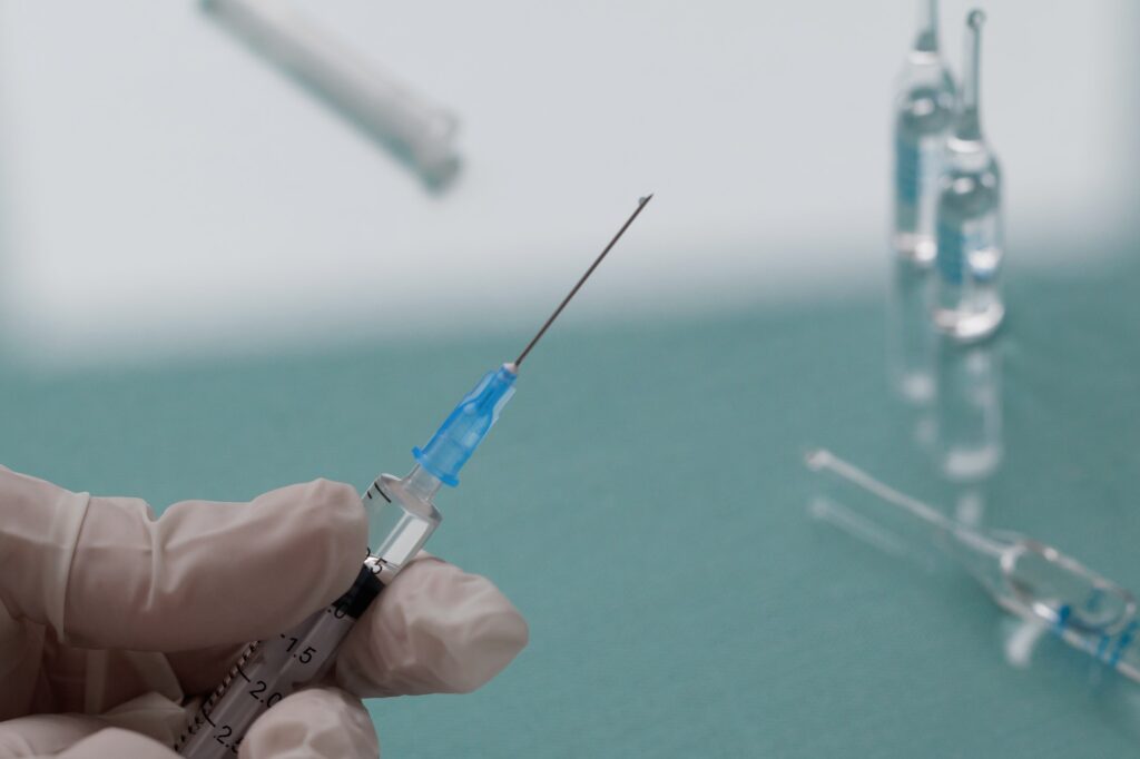 Doctor holds a syringe with a injection.